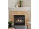 Close-up of a cozy fireplace with tiled surround and stylish mantle decor at 10176 Park Meadows Dr # 2408, Lone Tree, CO 80124