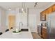 Modern kitchen with stainless steel appliances, large island, and access to other rooms at 10176 Park Meadows Dr # 2408, Lone Tree, CO 80124