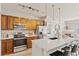 Bright kitchen features stainless steel appliances, a breakfast bar, and stylish pendant lighting at 10176 Park Meadows Dr # 2408, Lone Tree, CO 80124