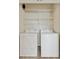 A convenient laundry closet provides space for a full-size washer and dryer, plus wire shelving for supplies at 10176 Park Meadows Dr # 2408, Lone Tree, CO 80124