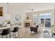 Comfortable living room with fireplace, large window, and view to kitchen area at 10176 Park Meadows Dr # 2408, Lone Tree, CO 80124