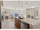 Kitchen island looking out to the well-lit living room with fireplace and outside views at 10176 Park Meadows Dr # 2408, Lone Tree, CO 80124