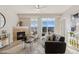 Bright living room with a fireplace, modern decor, and expansive windows at 10176 Park Meadows Dr # 2408, Lone Tree, CO 80124