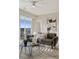 Sunlit living room features a modern ceiling fan, stylish furniture, and a scenic view from the sliding glass door at 10176 Park Meadows Dr # 2408, Lone Tree, CO 80124