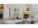 Modern living room with fireplace, stylish decor, and an open layout connecting to the kitchen at 10176 Park Meadows Dr # 2408, Lone Tree, CO 80124
