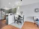 Dining area next to an updated kitchen featuring wood floors, modern colors and finishes at 5487 Balsam Ct, Arvada, CO 80002