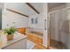 Bright bathroom featuring a shower, bathtub, and wood accents at 638 Kinnikinnik Hl, Golden, CO 80401