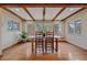 Dining room featuring hardwood floors, a view, wooden beams, and a dining table at 638 Kinnikinnik Hl, Golden, CO 80401
