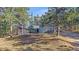 Beautiful blue house nestled among towering trees with a well-maintained lawn at 638 Kinnikinnik Hl, Golden, CO 80401