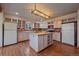 Bright kitchen with center island, hardwood floors, light cabinets and stainless steel appliances at 638 Kinnikinnik Hl, Golden, CO 80401