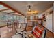 Kitchen featuring hardwood floors, wooden beams, island and adjacent dining area at 638 Kinnikinnik Hl, Golden, CO 80401