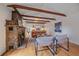 Bright living room with exposed beams, stone fireplace, and hardwood floors at 638 Kinnikinnik Hl, Golden, CO 80401