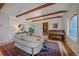 Bright living room with a piano, wooden floors, and a large decorative rug at 638 Kinnikinnik Hl, Golden, CO 80401