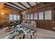 Charming living room with wood paneled walls, wood beams, and ample natural light at 638 Kinnikinnik Hl, Golden, CO 80401