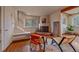 Bright living area with a fireplace, hardwood floors, and a staircase visible through a window at 638 Kinnikinnik Hl, Golden, CO 80401