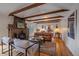 Cozy living room with exposed beams, stone fireplace, and hardwood floors at 638 Kinnikinnik Hl, Golden, CO 80401
