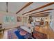 Spacious living room features exposed beams and an open floor plan with hardwood floors at 638 Kinnikinnik Hl, Golden, CO 80401