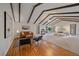 Spacious main bedroom with hardwood floors, beamed ceilings, ample natural light and cozy sitting area at 638 Kinnikinnik Hl, Golden, CO 80401