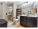 Bathroom featuring a glass-door shower and a vanity with dark wood cabinets and a white countertop at 4937 Hogback Ridge Rd, Morrison, CO 80465