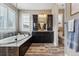 Well-appointed bathroom showcasing a soaking tub, dark wood cabinets, and modern fixtures at 4937 Hogback Ridge Rd, Morrison, CO 80465