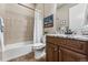 Well-lit bathroom with granite countertops, wooden cabinets, and a shower-tub combination at 4937 Hogback Ridge Rd, Morrison, CO 80465