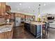 Spacious kitchen featuring granite countertops, stainless steel appliances, and custom cabinets at 4937 Hogback Ridge Rd, Morrison, CO 80465