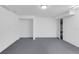 Unfinished basement with gray carpet, white walls, and an open closet space at 23612 E Mississippi Cir, Aurora, CO 80018