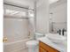 Bright bathroom with white tiled walls, a tub, and a vessel sink on a wood vanity at 23612 E Mississippi Cir, Aurora, CO 80018