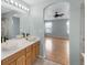 Bathroom featuring dual vessel sinks, wood cabinets, and an arched entry to bedroom at 23612 E Mississippi Cir, Aurora, CO 80018