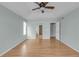 Bedroom with wood floors, arched entry, tray ceiling with fan and neutral color palette at 23612 E Mississippi Cir, Aurora, CO 80018