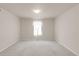 Empty bedroom with neutral carpet, paint, and trim, illuminated by natural light from a window at 23612 E Mississippi Cir, Aurora, CO 80018