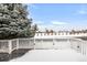 A snowy deck with a view of a snow-covered landscape and evergreen trees at 23612 E Mississippi Cir, Aurora, CO 80018