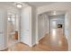 Hallway with hardwood floors leading to a full bathroom and the living room with a fireplace at 23612 E Mississippi Cir, Aurora, CO 80018