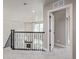 Upstairs hallway with a view into living area below at 12224 Olive Way, Thornton, CO 80602