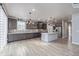 Spacious kitchen with dark cabinets, white island, and herringbone backsplash at 12224 Olive Way, Thornton, CO 80602