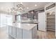 Bright kitchen boasts dark cabinetry, herringbone backsplash, and an expansive island at 12224 Olive Way, Thornton, CO 80602