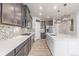 Modern kitchen with dark cabinets, quartz countertops, and stainless steel appliances at 12224 Olive Way, Thornton, CO 80602