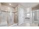 Large walk-in shower with glass enclosure, tiled walls, and built-in seat at 12224 Olive Way, Thornton, CO 80602