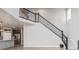 Elegant staircase with wrought-iron railing leading to the upper level at 12224 Olive Way, Thornton, CO 80602