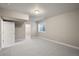 A spare bedroom with neutral carpet and paint, offering ample space for storage and closets at 9587 Kentwick Cir, Englewood, CO 80112