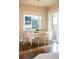 Well-lit dining area with wood floors, large windows, and sliding glass door access to the outside at 9587 Kentwick Cir, Englewood, CO 80112