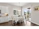 Bright dining area featuring hardwood floors, a view to the deck, and a stylish chandelier at 9587 Kentwick Cir, Englewood, CO 80112