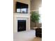 Close-up of the modern fireplace with decorative mantle, set beneath a mounted TV screen at 9587 Kentwick Cir, Englewood, CO 80112