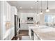 Bright kitchen featuring stainless steel appliances, white cabinets, granite countertops, a stylish faucet, and hardwood floors at 9587 Kentwick Cir, Englewood, CO 80112