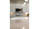 Close-up of a kitchen with stainless steel microwave, white cabinetry, tile backsplash and granite countertops and chrome faucet at 9587 Kentwick Cir, Englewood, CO 80112