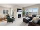 Comfortable living room with a fireplace, a mounted TV, and an adjacent dining area at 9587 Kentwick Cir, Englewood, CO 80112