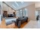 Inviting living room with a vaulted ceiling, brick fireplace, hardwood floors, and skylights at 5470 S Jasper Way, Centennial, CO 80015