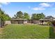 Spacious backyard with green grass, brick home, gazebo, and a wooden privacy fence at 2175 S Joliet St, Aurora, CO 80014