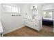 Stylish bathroom showcasing modern vanity, circular mirror, and wood-look flooring at 2175 S Joliet St, Aurora, CO 80014