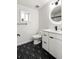 Bathroom with modern vanity, backlit mirror, and striking black and white patterned floor at 2175 S Joliet St, Aurora, CO 80014